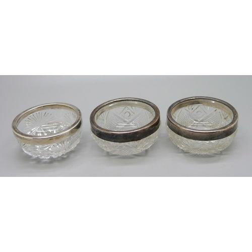 817 - A pair of silver rimmed glass salts and one other