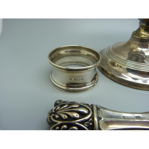 821 - A pair of small candlesticks, one a/f, a silver vesta case, a silver pusher, a silver napkin ring, e... 