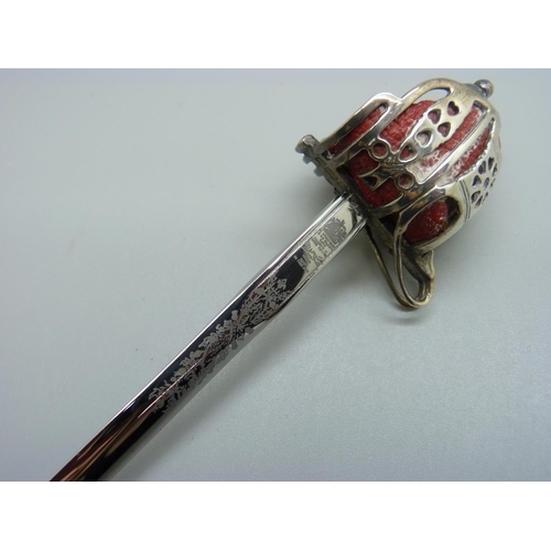 822 - A hallmarked silver handled letter opener in the form of a sword, the blade marked Wilkinson, 17.5cm