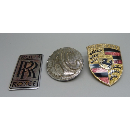 844 - Three car badges, Porsche, Rolls-Royce and AC