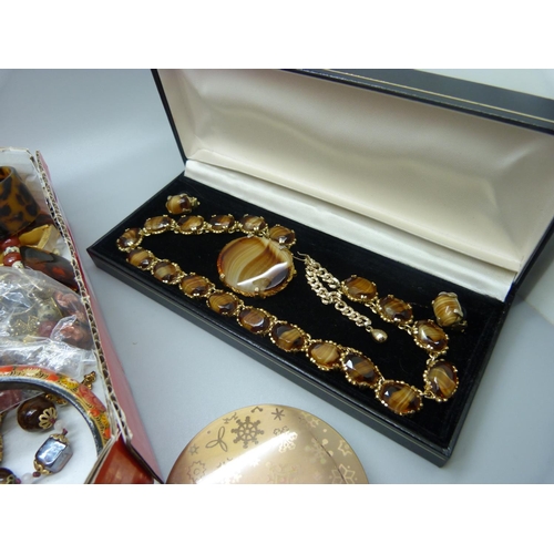 869 - Costume jewellery and a compact