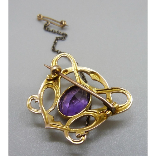 874 - An Art Nouveau 15ct gold and amethyst brooch, 5.4g, 31mm wide