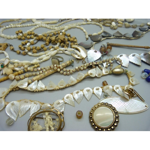 900 - Mother of pearl and other jewellery, and lace bobbins