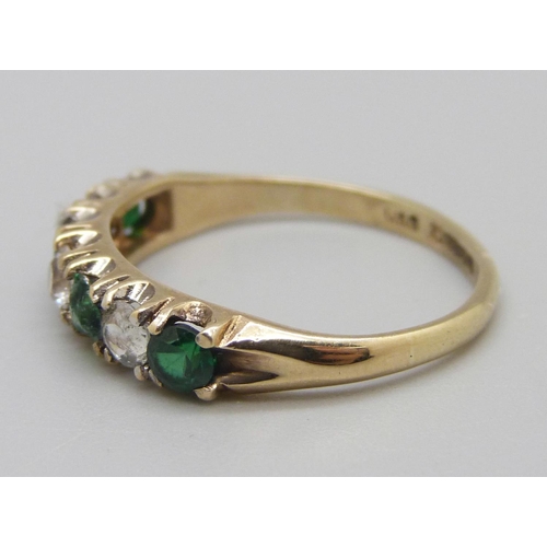 917 - A 9ct gold green and white stone ring, one stone replaced, 2.1g, P