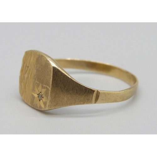 930 - A 9ct gold signet ring set with a diamond, 2.1g, U