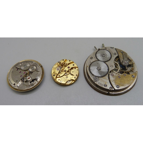 946 - A Longines pocket watch movement, a Longines wristwatch movement and a JW Benson wristwatch movement