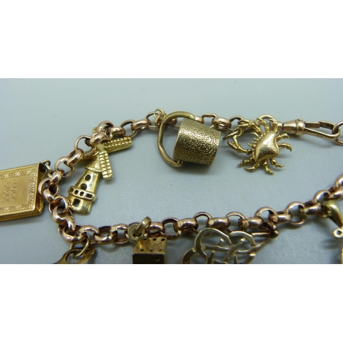 964 - A 9ct gold bracelet with nine charms, two charms hallmarked 9ct gold, the others marked 9k, 9ct or 3... 