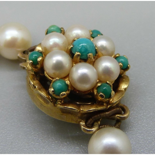 979 - A string of pearls with a 9ct gold clasp, set with turquoise and pearls