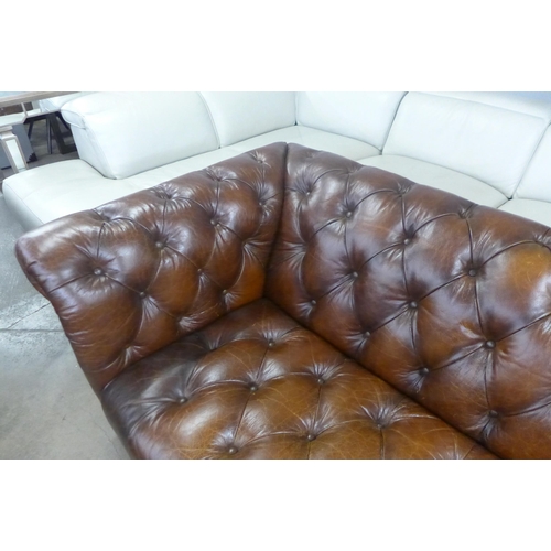 1570 - A brown leather Chesterfield three seater sofa