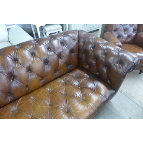 1570 - A brown leather Chesterfield three seater sofa