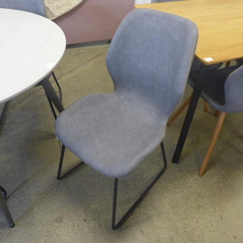 1614 - A Logan round table with four Callum light grey dining chairs