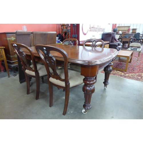 144 - A Victorian mahogany extending dining table and four chairs