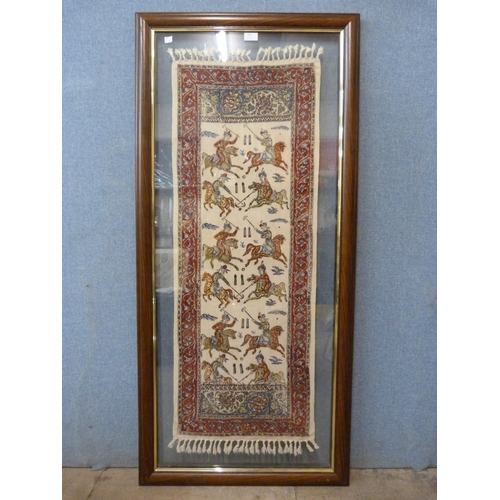 364 - A framed Iranian wall hanging depicting polo players