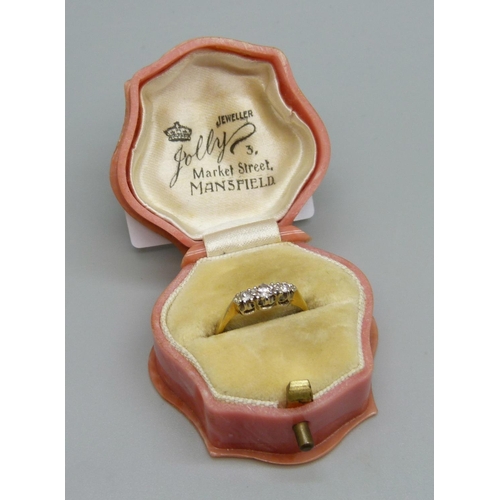 1031 - An 18ct gold, platinum set three stone diamond ring, 1.6g, I, in a vintage pink Bakelite box