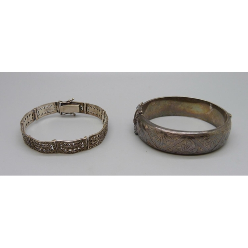 1039 - A silver bangle, dented, and a silver and marcasite bracelet