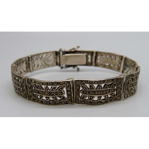 1039 - A silver bangle, dented, and a silver and marcasite bracelet