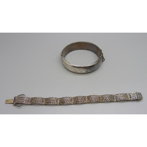 1039 - A silver bangle, dented, and a silver and marcasite bracelet