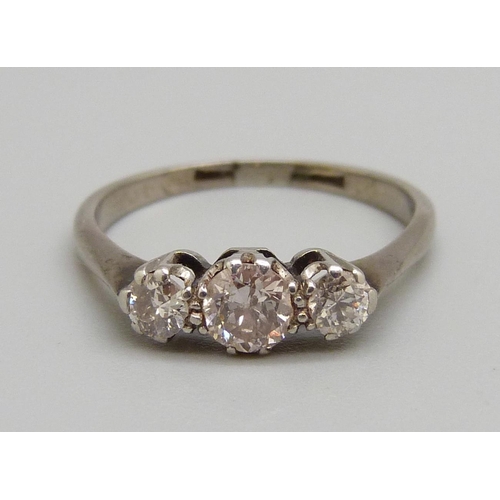 1050 - A white metal set three stone diamond ring, 2.7g, O, centre stone approximately 0.4ct diamond weight