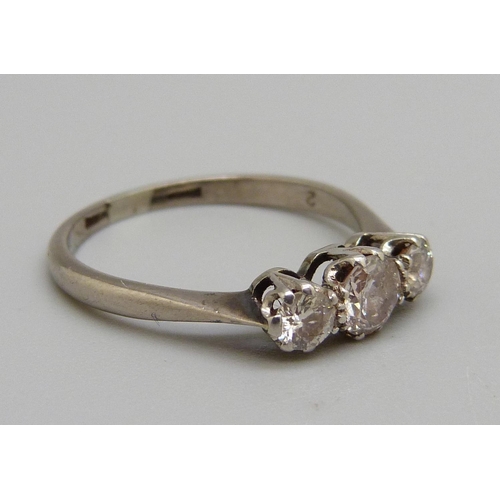 1050 - A white metal set three stone diamond ring, 2.7g, O, centre stone approximately 0.4ct diamond weight