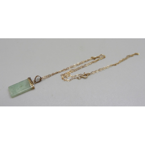 1052 - A 9ct gold mounted jade pendant on a fine 9ct gold chain