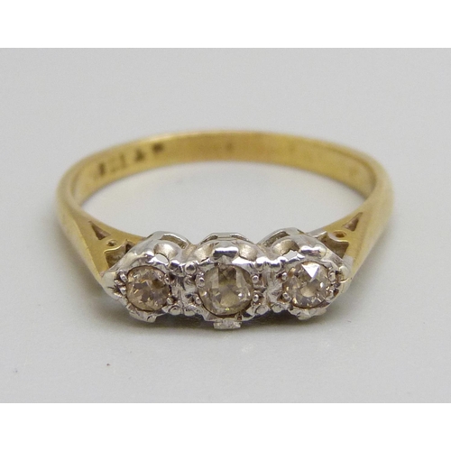 1056 - An 18ct gold, platinum set three stone diamond ring, 2.5g, N