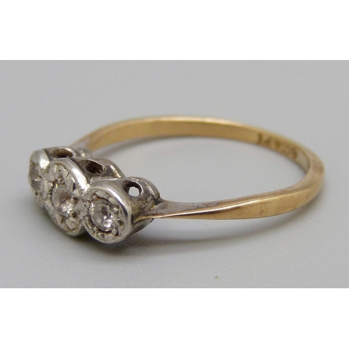 1060 - An 18ct gold, platinum set three stone diamond ring, 2.4g, L