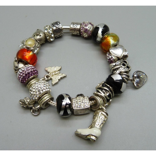 1074 - A Rhona Sutton silver bracelet, with charms