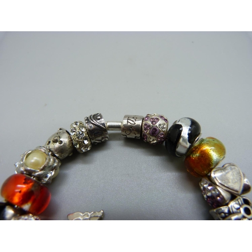 1074 - A Rhona Sutton silver bracelet, with charms