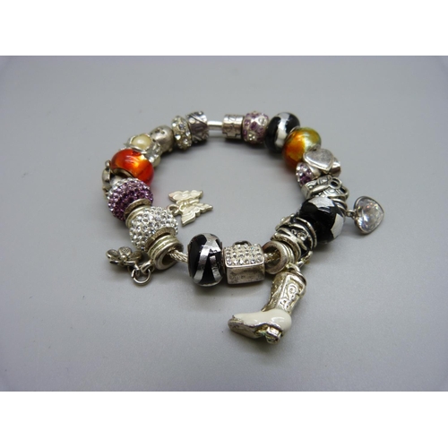 1074 - A Rhona Sutton silver bracelet, with charms