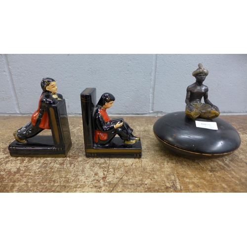 1102 - A carved wooden pot with figure and a pair of bookends, a/f