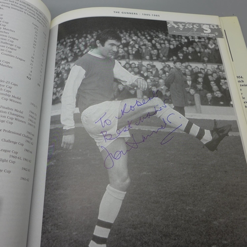 668 - Football; a copy of Arsenal Who's Who containing over 30 signatures from former players including Jo... 