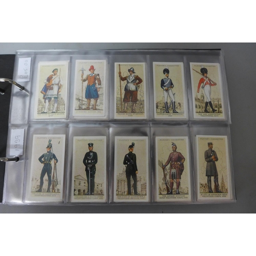 693 - Cigarette cards;-an album of military related cards with eleven complete sets including Player’s Vic... 