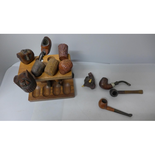 705 - A collection of pipes, some with carved bowls including skull, bulls head, chief and clog, (#35)