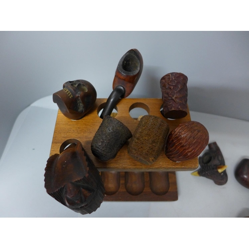 705 - A collection of pipes, some with carved bowls including skull, bulls head, chief and clog, (#35)