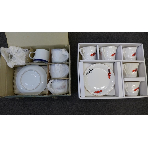 748 - A Japanese Koi carp decorated porcelain tea service and one other similar tea service