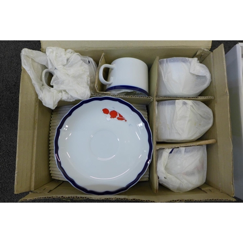 748 - A Japanese Koi carp decorated porcelain tea service and one other similar tea service