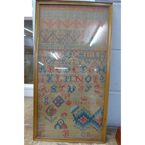 789 - A framed sampler dated 1711, 65cm