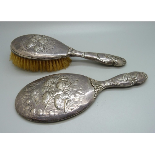 819 - Two silver backed brushes decorated with Reynolds angels, a/f