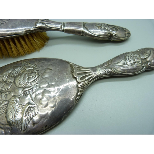 819 - Two silver backed brushes decorated with Reynolds angels, a/f