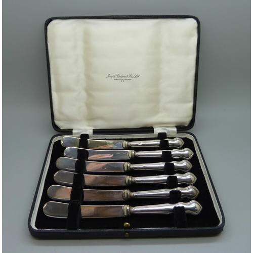 820 - A cased set of six dessert knives, Sheffield 1923, with silver covered handles