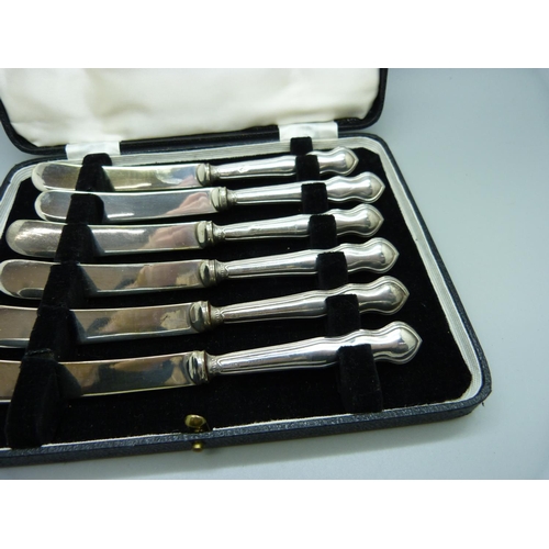 820 - A cased set of six dessert knives, Sheffield 1923, with silver covered handles