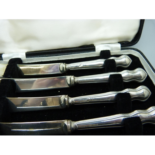 820 - A cased set of six dessert knives, Sheffield 1923, with silver covered handles