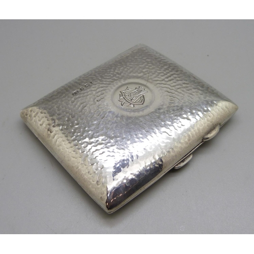 823 - A hammered silver cigarette case, with monogram, Birmingham 1908, 97g, 70mm x 83mm