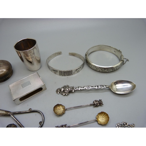 845 - Two silver bangles, a pair of silver Lincoln Imp salt spoons, a silver matchbox case, a silver shot,... 