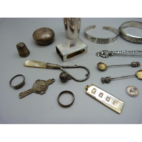 845 - Two silver bangles, a pair of silver Lincoln Imp salt spoons, a silver matchbox case, a silver shot,... 