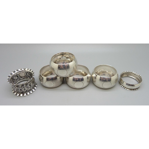 869 - A set of four silver napkin rings and two other silver napkin rings, 105g