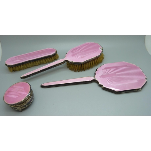 871 - A silver and pink enamel hand mirror, two brushes and a trinket pot, a/f