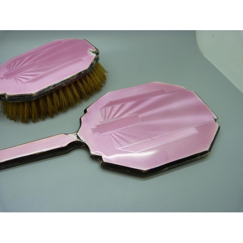 871 - A silver and pink enamel hand mirror, two brushes and a trinket pot, a/f