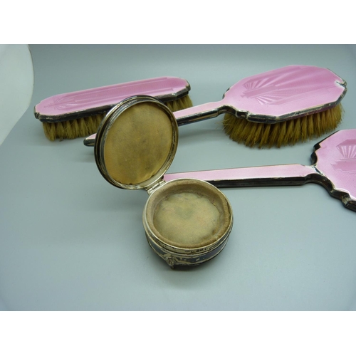 871 - A silver and pink enamel hand mirror, two brushes and a trinket pot, a/f