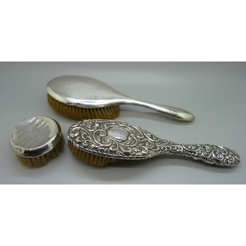 880 - Three silver backed brushes, a/f